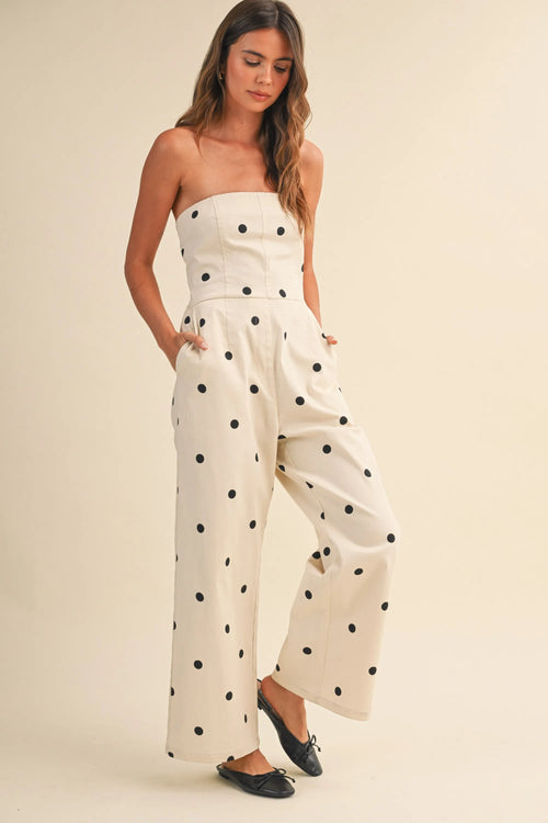 A creamy off-white strapless wide leg jumpsuit with bold black polka dots in stretch twill fabric
