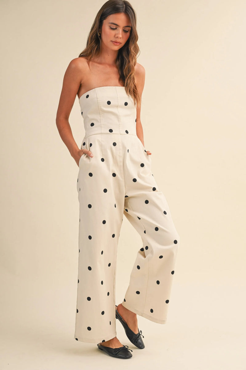 A creamy off-white strapless wide leg jumpsuit with bold black polka dots in stretch twill fabric