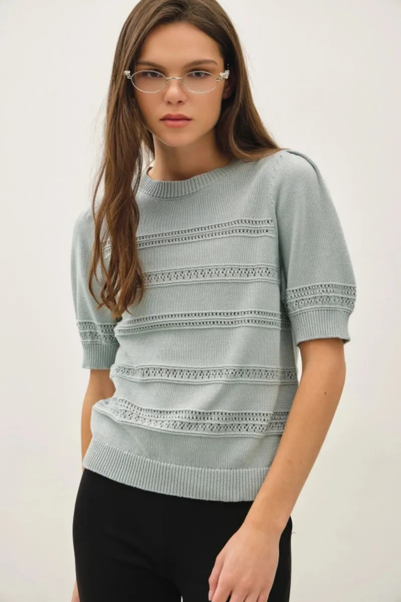 A light blue knitted crochet striped puff sleeve sweater with short sleeves and horizontal lace detailing