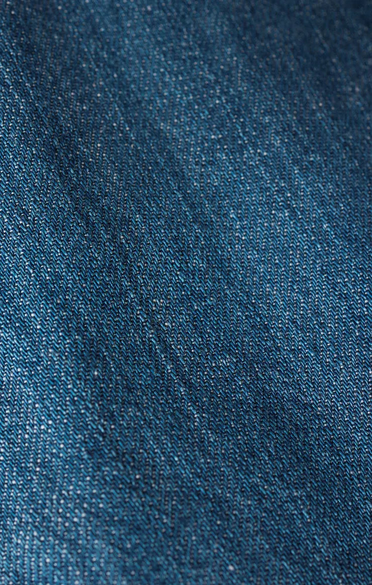 Dark blue textured woven angel eyes denim mini dress fabric detail showing durable denim material