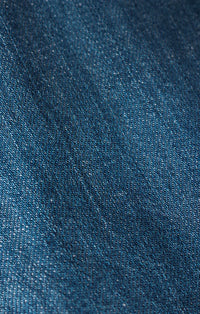 Dark blue textured woven angel eyes denim mini dress fabric detail showing durable denim material