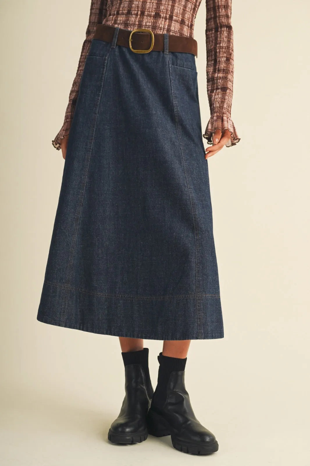 Dark blue denim straight cut maxi skirt with visible hem stitching in belted indigo maxi skirt style