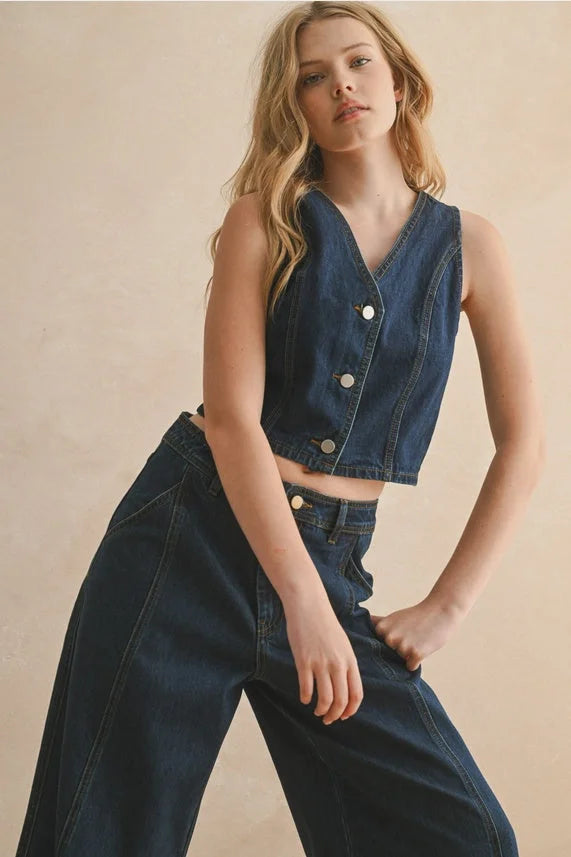 Dark blue sleeveless denim vest with v-neck and button closure for women’s boho chic clothing