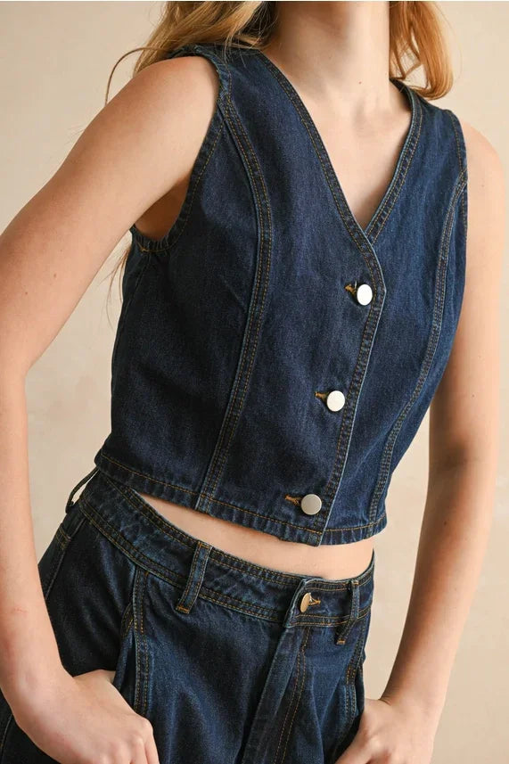 Dark blue sleeveless denim vest with V-neck and white buttons for women’s boho chic clothing