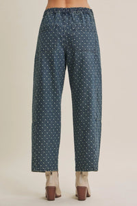 Dark blue jacquard polka dot barrel leg jeans showing back side with two pockets and distinctive polka dot pattern
