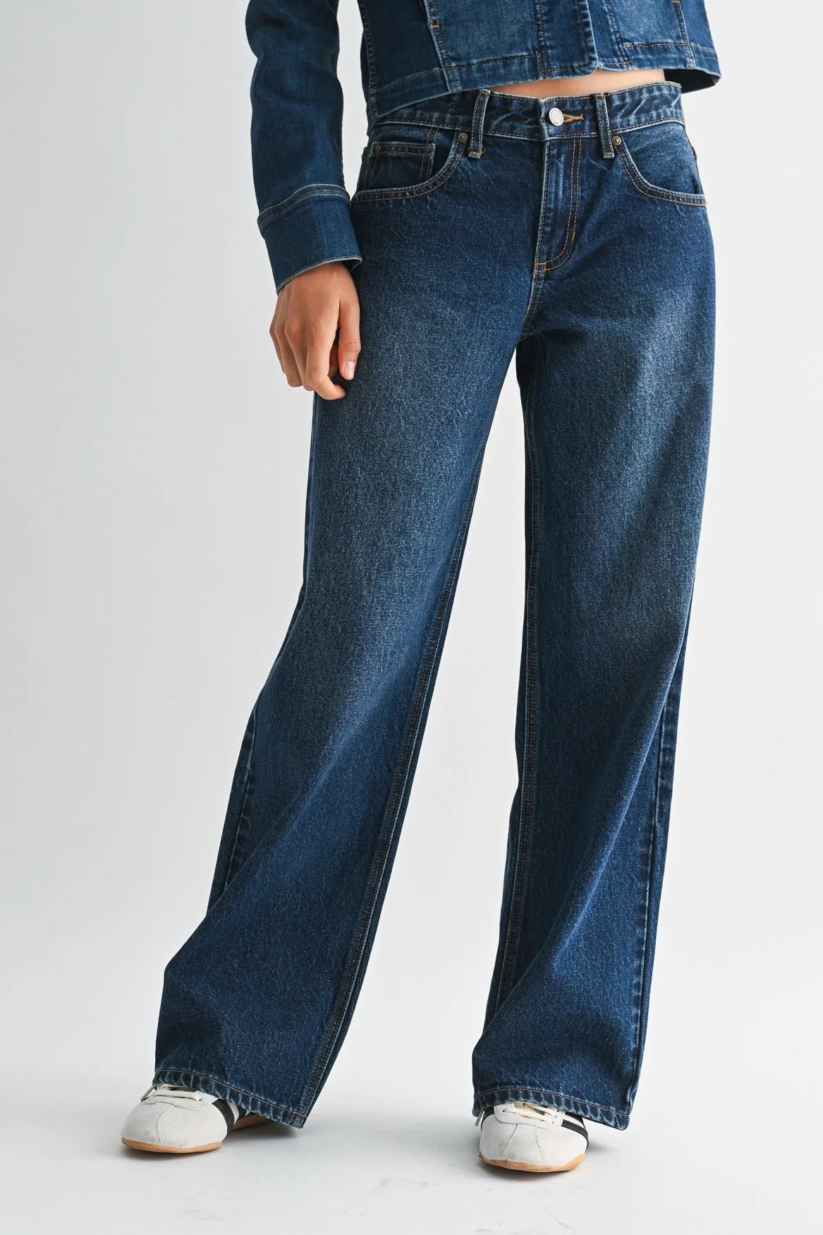 Dark blue denim jeans with a low rise baggy wide leg cut and classic five-pocket design