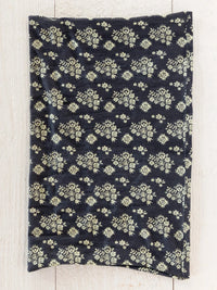 Dark blue boho bandeau headband with cream floral motifs featuring black cluster medallions pattern