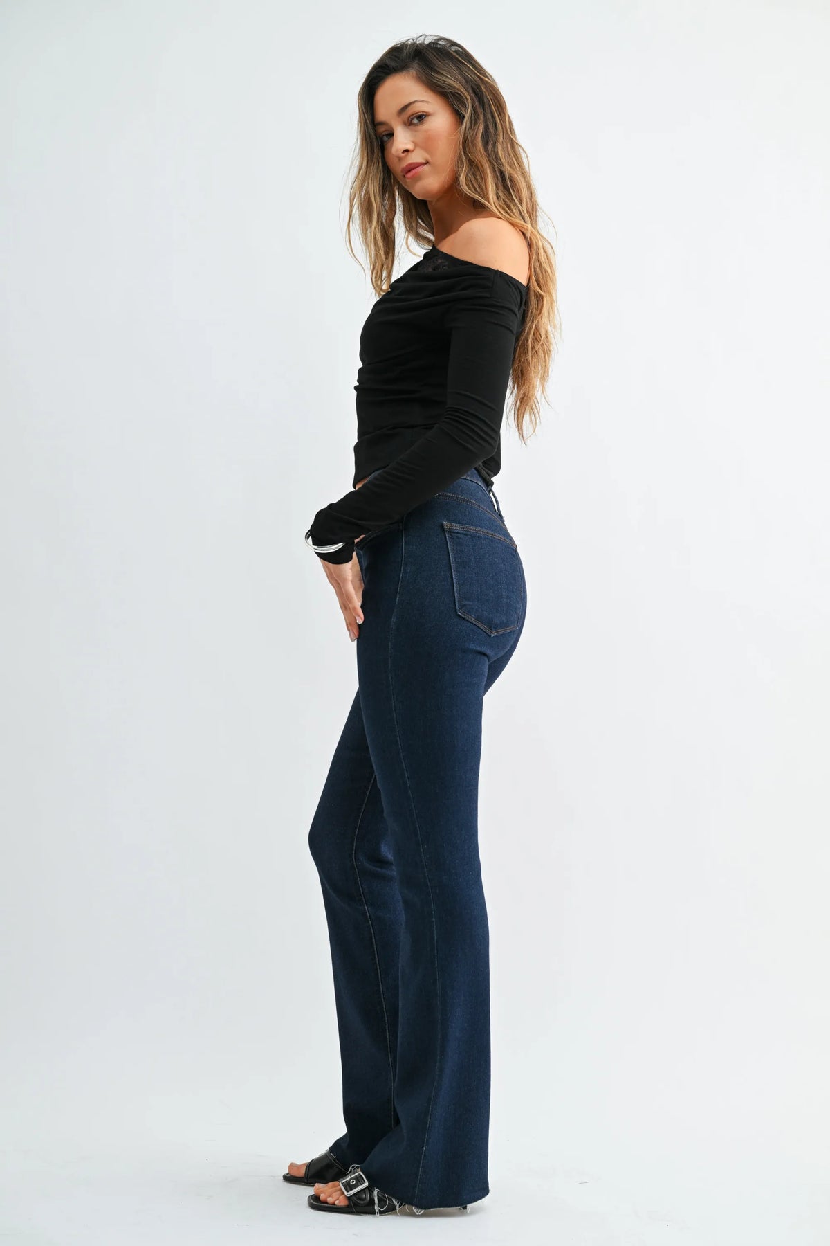 Dark blue high-waisted slim bootcut jeans with scissor cut featuring classic denim texture and subtle thigh fading