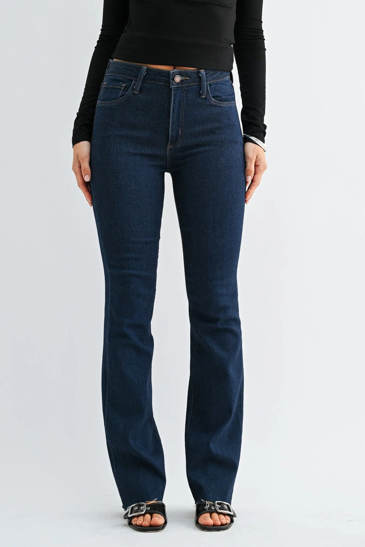 Dark blue high-waisted slim bootcut jeans with flared denim, five-pocket design, and silver-toned hardware