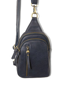Skyler sling bag is a dark blue leather crossbody bag with multiple compartments and gold-tone hardware