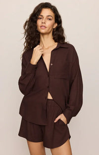 A loose-fitting dark brown alfie linen button up shirt with long sleeves and a collar made from lightweight linen