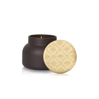 Dark brown ceramic capri blue artisan terrazza velluto candle jar with gold embossed lid and lit wick 19 oz signature candle