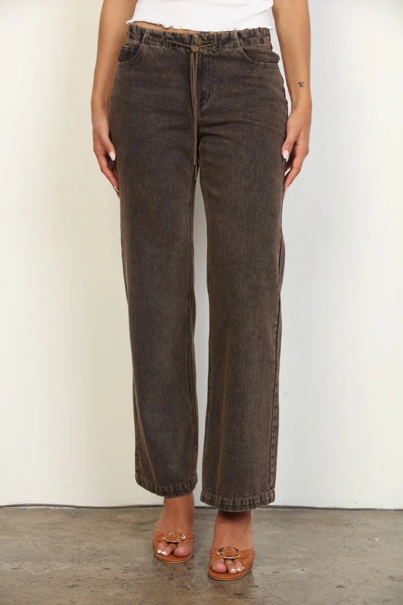 Dark brown overdyed straight leg denim jeans with faded wash and classic five-pocket design in wide-leg style