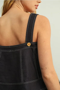Dark denim stitch detailed sleeveless top with white stitching and wooden button on shoulder strap