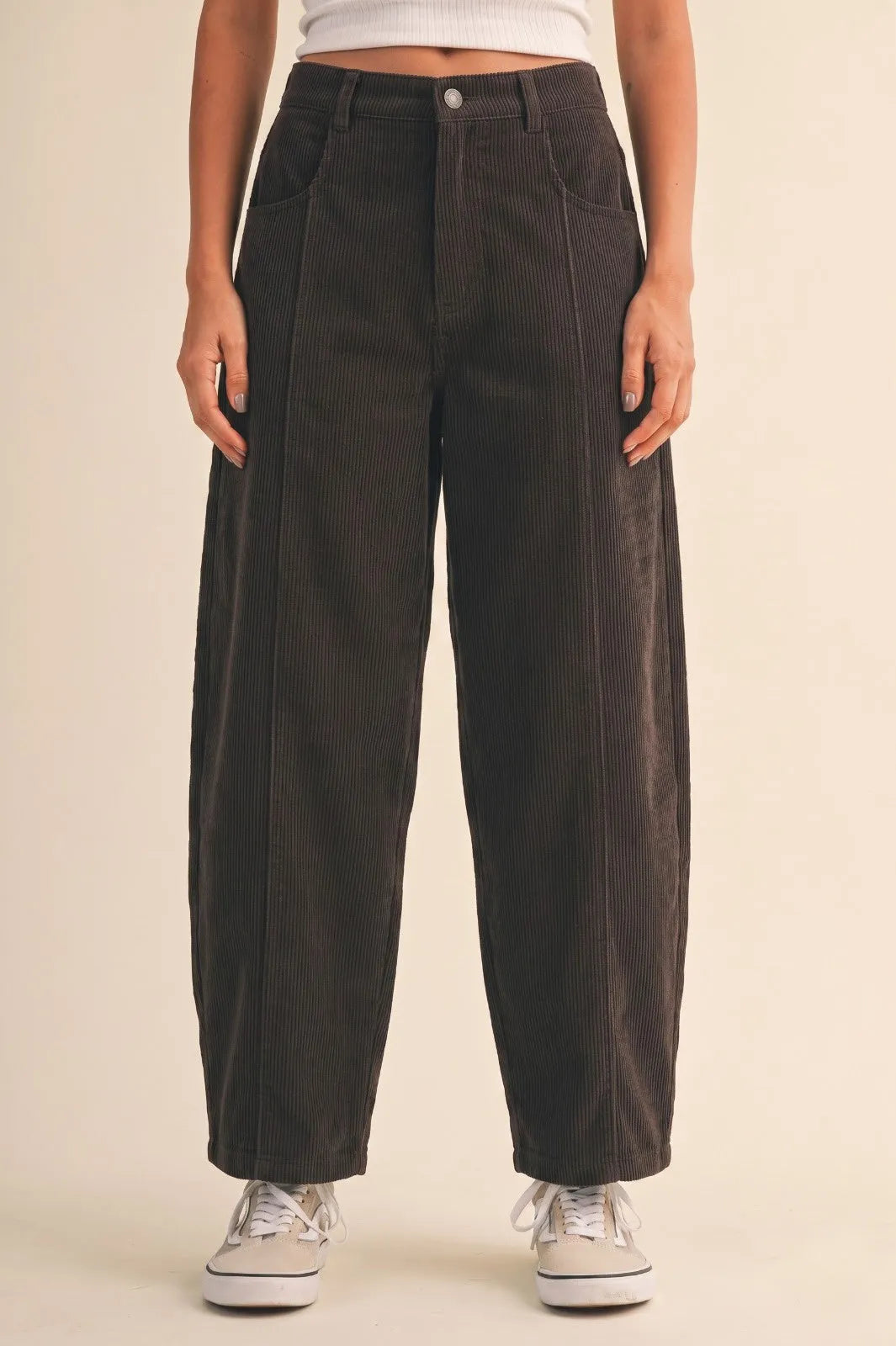 Dark gray mid rise corduroy barrel pants featuring wide-leg design and subtle vertical ribbing in corduroy fabric