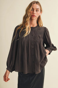 A dark gray long-sleeved blouse with a pintuck bib ruffle collar and button-down front for elegant wear