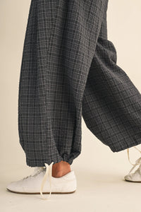 Dark gray plaid cotton trousers with a relaxed fit featuring drawcord waistline plaid and adjustable ankles waistband