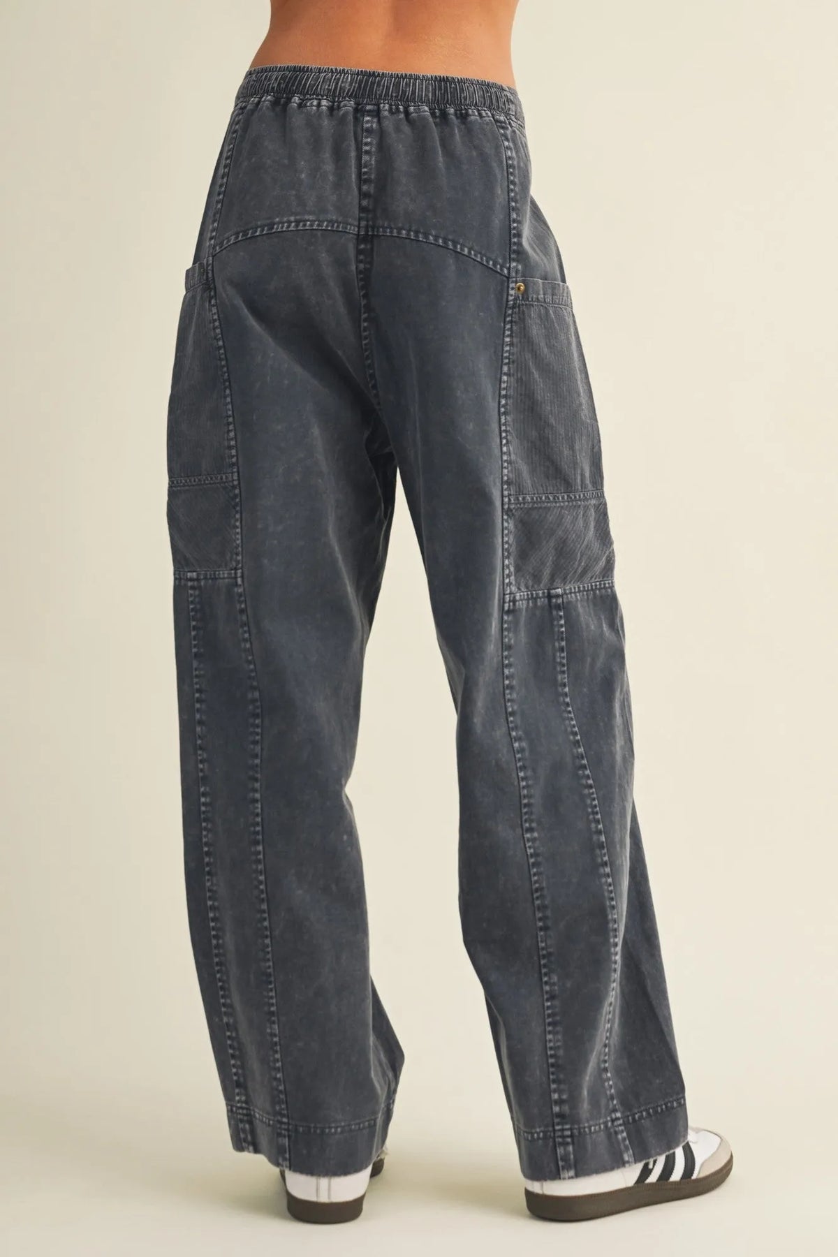 Dark gray wide leg utility denim pants with drawstring waist and multiple patch pockets for a relaxed fit