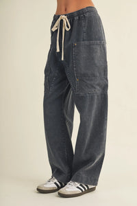 Dark gray wide leg utility pants made of denim with a drawstring waist wide and large patch pockets