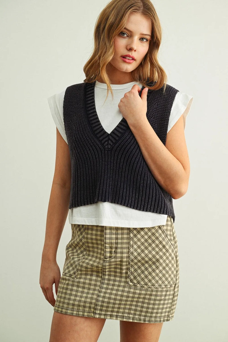 Dark navy ribbed knit v-neck sweater vest worn over a white jersey top in sweater vest with jersey top combo product