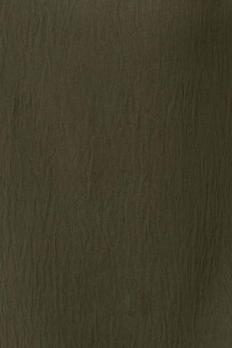Dark olive-green textured short roll up sleeve top with subtle grain pattern from shop daisy women’s boho chic clothing