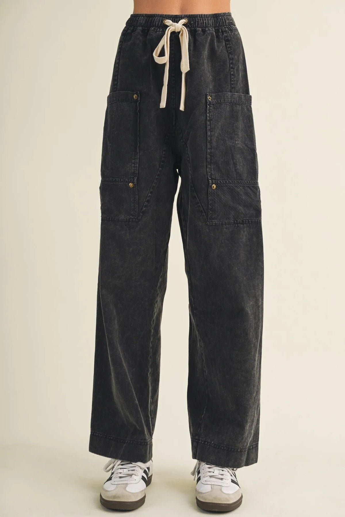 Dark-wash denim drawstring waist wide leg utility pants with two large front pockets for a casual look