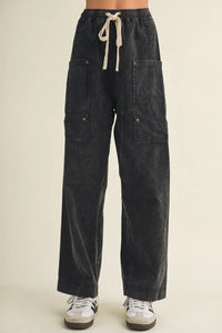 Dark-wash denim drawstring waist wide leg utility pants with two large front pockets for a casual look