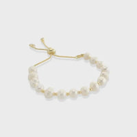 Genuine pearl drawstring bracelet featuring irregular white pearls on a gold-toned adjustable cord with metal clasps