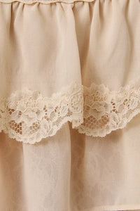 A delicate cream lace trim layered crop top with ruffled fabric and matching lace trim along the hem
