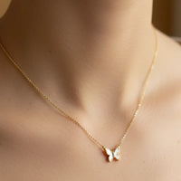 Gold dipped mini butterfly pendant necklace with white enamel wings and gemstones