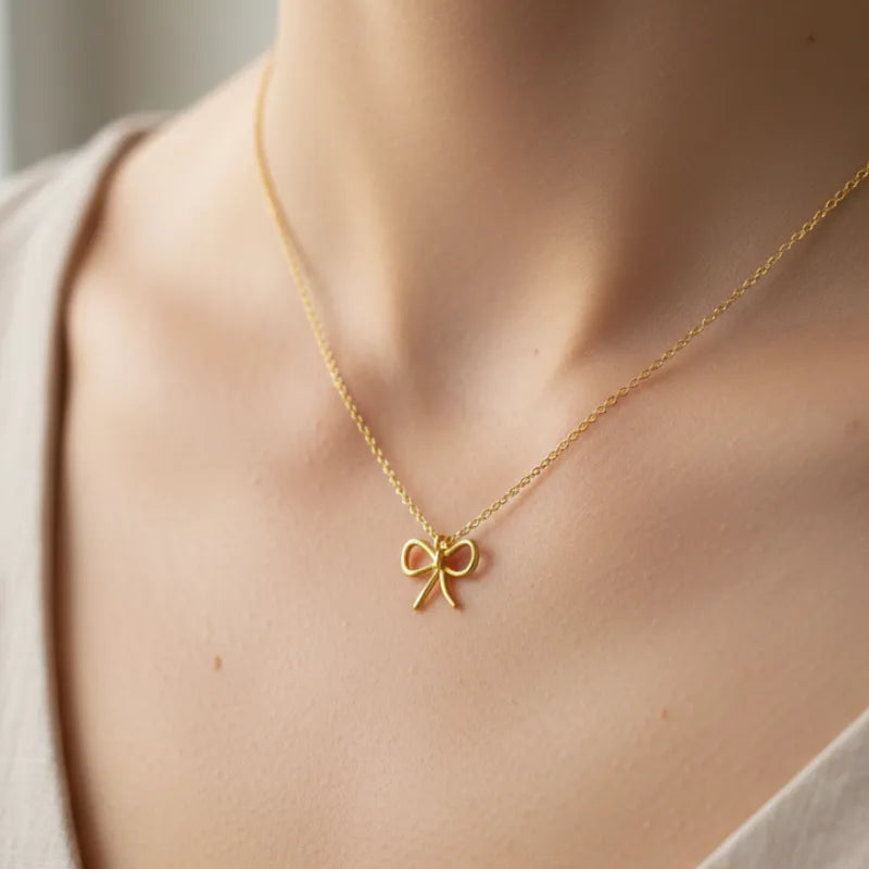 Gold dipped wire ribbon bow pendant necklace in delicate gold chain