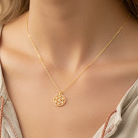 Delicate gold flower coin pendant necklace with geometric design and stones