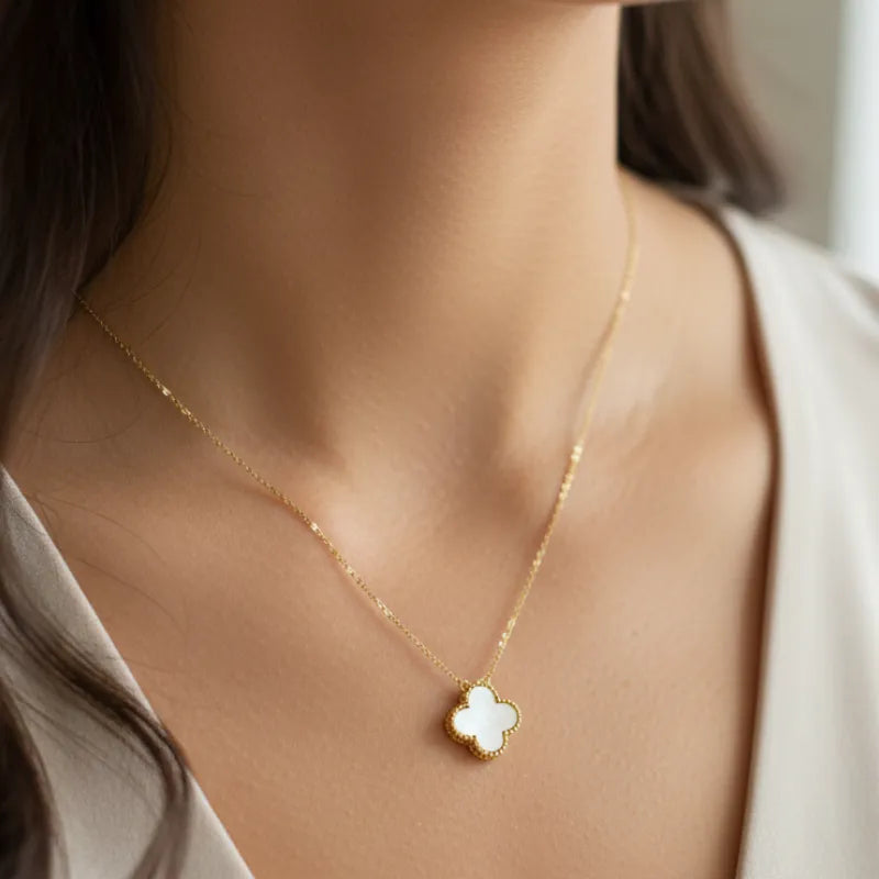Delicate gold clover pendant necklace with mother of pearl four-leaf design