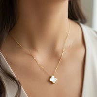 Delicate gold clover pendant necklace with mother of pearl four-leaf design