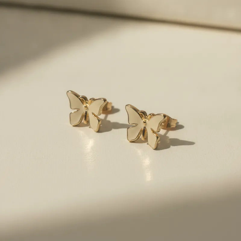 Delicate gold plated butterfly stud earrings with a smooth minimalist design perfect for chic nature-inspired style