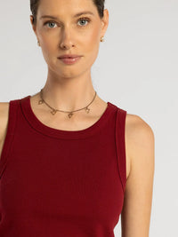 A delicate gold-toned necklace with small open triangle pendants complementing the edlin basic tank garment
