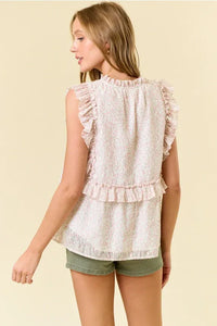 A delicate off-white ditsy floral split v neck lace top with ruffled sleeves and a tiered hemline