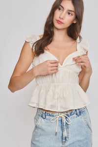 A delicate off-white embroidered ruffle sleeve blouse with a sweetheart neckline and gathered waistband crop top