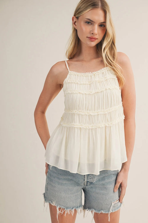 Off-white tiered ruffle bodice babydoll cami with thin spaghetti straps and a delicate ruffle bodice hem