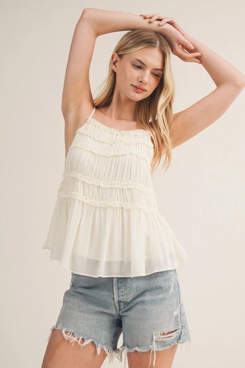 Delicate off-white tiered ruffle bodice babydoll cami with ruffled layers and thin spaghetti straps
