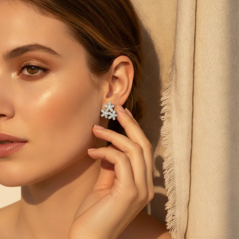 Dainty blue floral blossom stud earrings in delicate silver with a sparkling crystalline finish for elegant wear