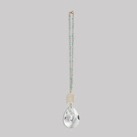 Delicate turquoise and gold pocket suncatcher necklace with clear teardrop pendant and sunburst design for women’s boho chic clothing