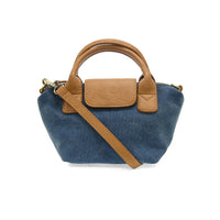 Denim blue abilene canvas mini tote crossbody with tan leather handles and flap closure made of canvas and leather