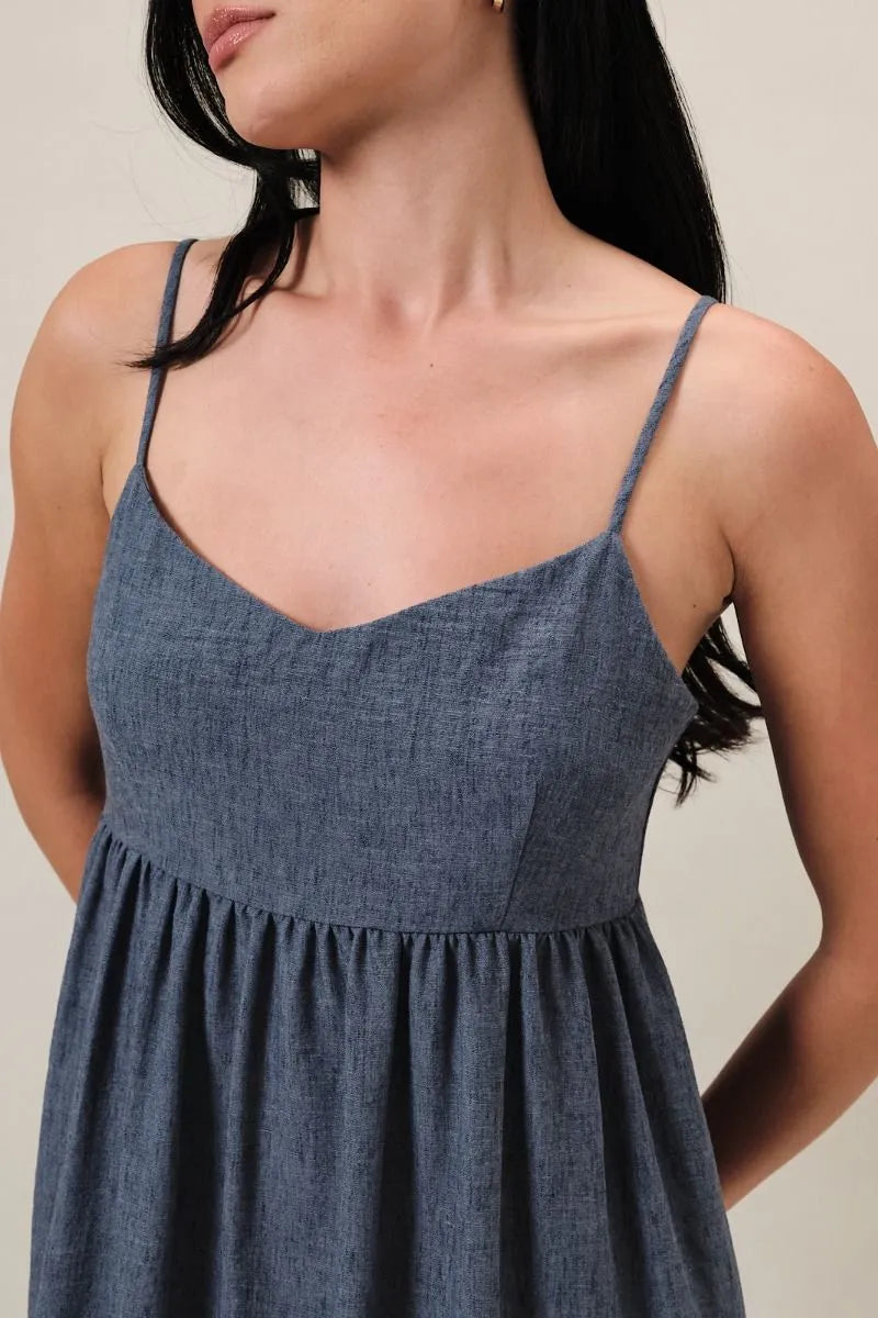 Denim blue sweet heart neck midi dress with textured fabric, gathered waist, and heart neck spaghetti straps