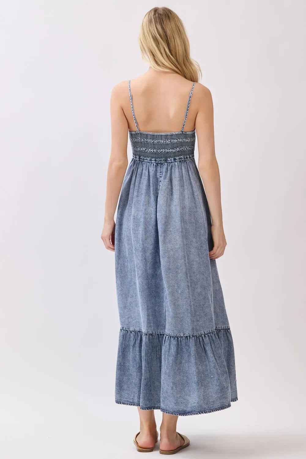 Denim blue tencel smocked tiered midi dress with delicate embroidery at waistband and thin spaghetti straps
