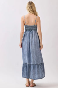 Denim blue tencel smocked tiered midi dress with delicate embroidery at waistband and thin spaghetti straps