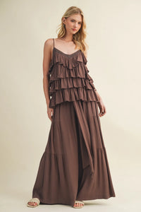 A flowing earthy brown maxi dress featuring cascading ruffle tiered bodice and soft draped skirt