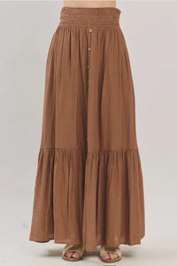 Earthy brown flowing tiered center slit maxi skirt with gathered waistband and tiered ruffles for elegant wear