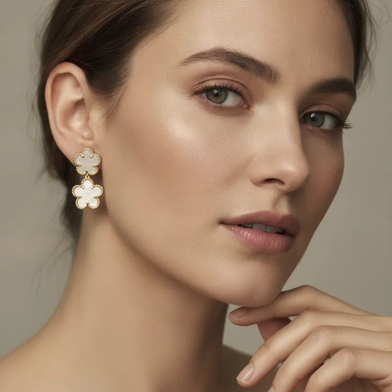 Elegant double flower mother of pearl gold drop earrings with two delicate gold-toned flowers and opal centers
