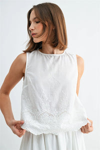 White sleeveless button blouse with delicate eyelet hem lace embroidery along the back blouse features